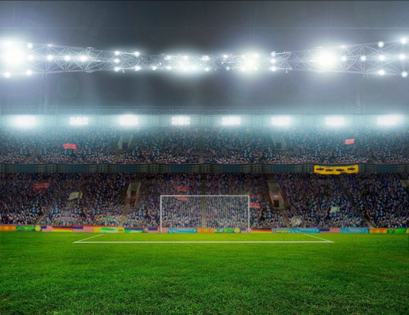 A soccer field with many fans in the stands.